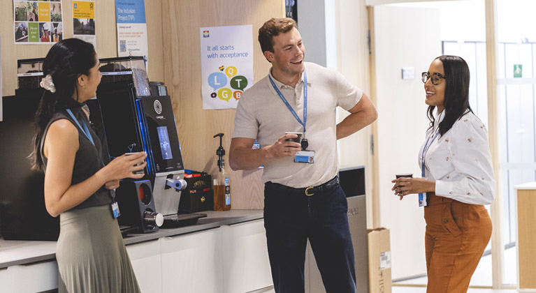 Three Yara employees chatting by coffee machine